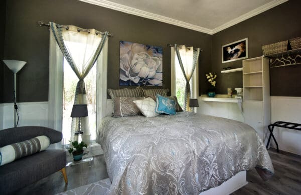 A bedroom with a bed, nightstand and window.