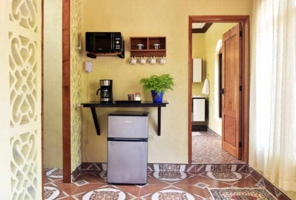 A kitchen with a refrigerator and microwave in it