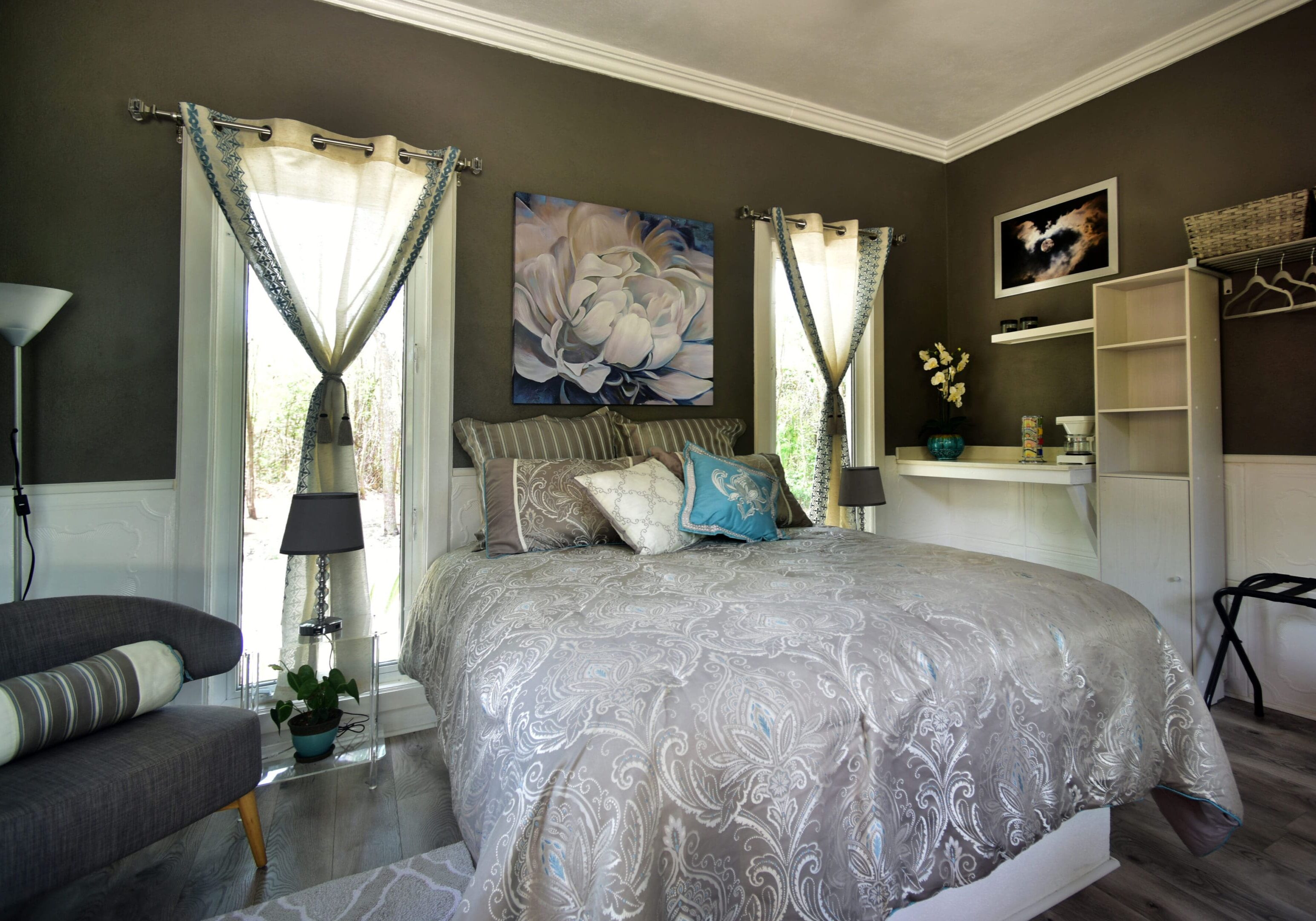 A bedroom with a bed, nightstand and window.